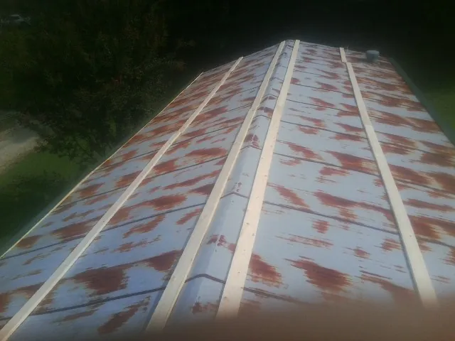 Rusted metal roof panels with new wood purlins before replacement — Storm Damage Roof Repair in Shrewsbury by Roofing Brothers